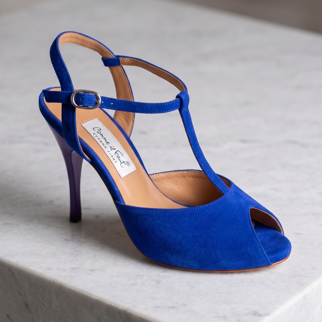 A single blue suede slingback high-heeled sandal with a T-strap and open toe.